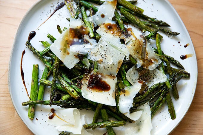 Roasted asparagus with balsamic and parmesan on a plate.