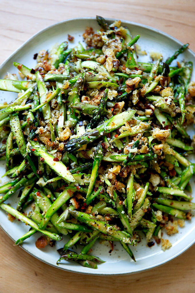 A raw asparagus salad on a platter.