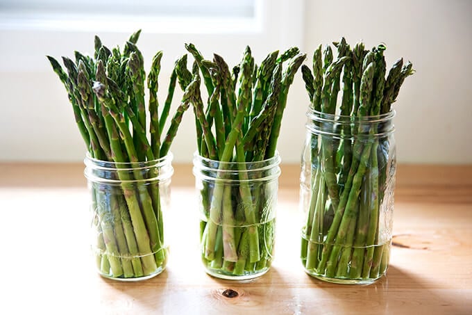 Asparagus in glass jars with a little bit of water.