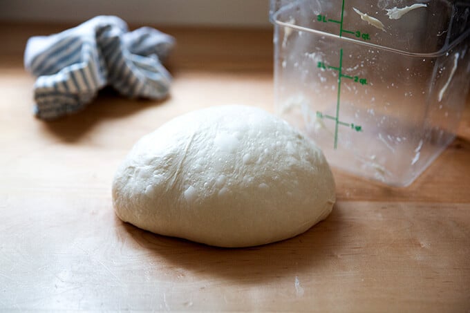 Ciabatta dough shaped into a round on the counter top.
