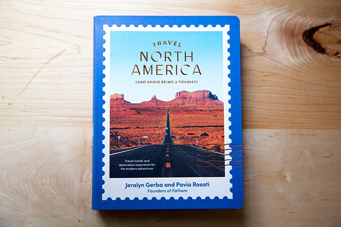 A book, Travel North America, on a counter.