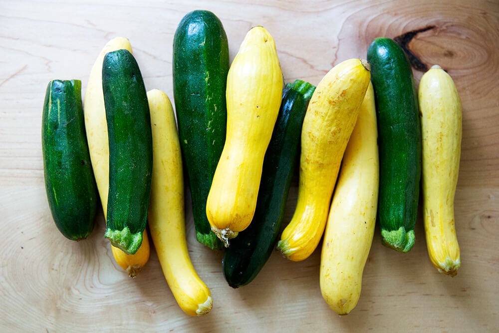 A pile of zucchini and summer squash on a countertop.