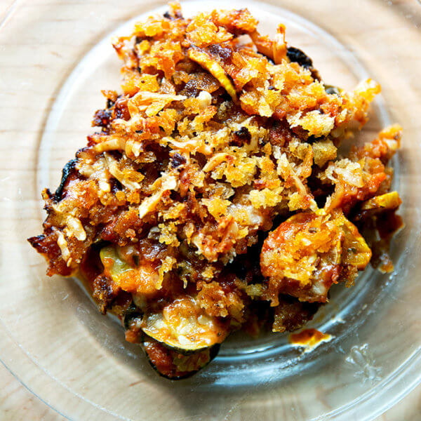 A slice of just-baked zucchini parmesan on a plate.