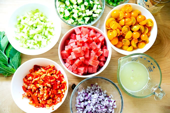 Ingredients to make watermelon gazpacho on a countertop.