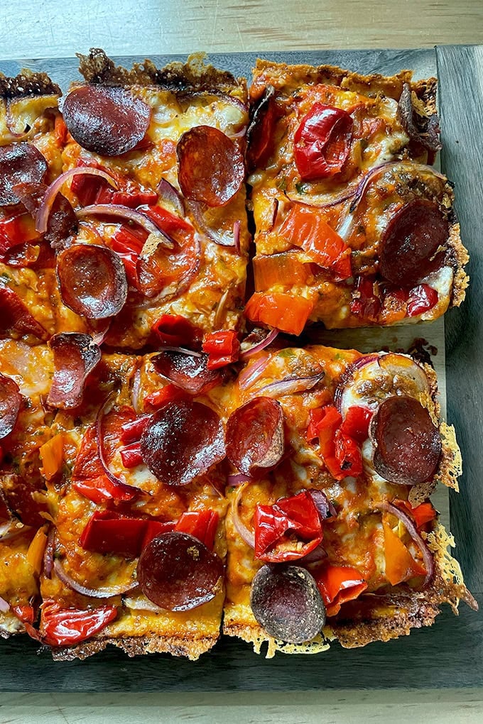 A just-baked Detroit-style pizza on a board. - 19