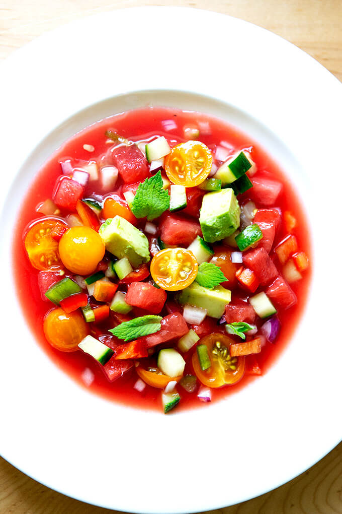 A white bowl filled with watermelon gazpacho.
