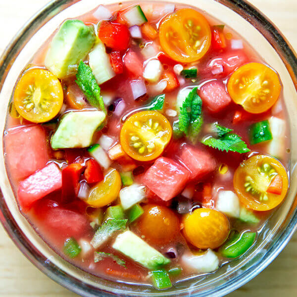 A glass bowl filled with watermelon gazpacho.
