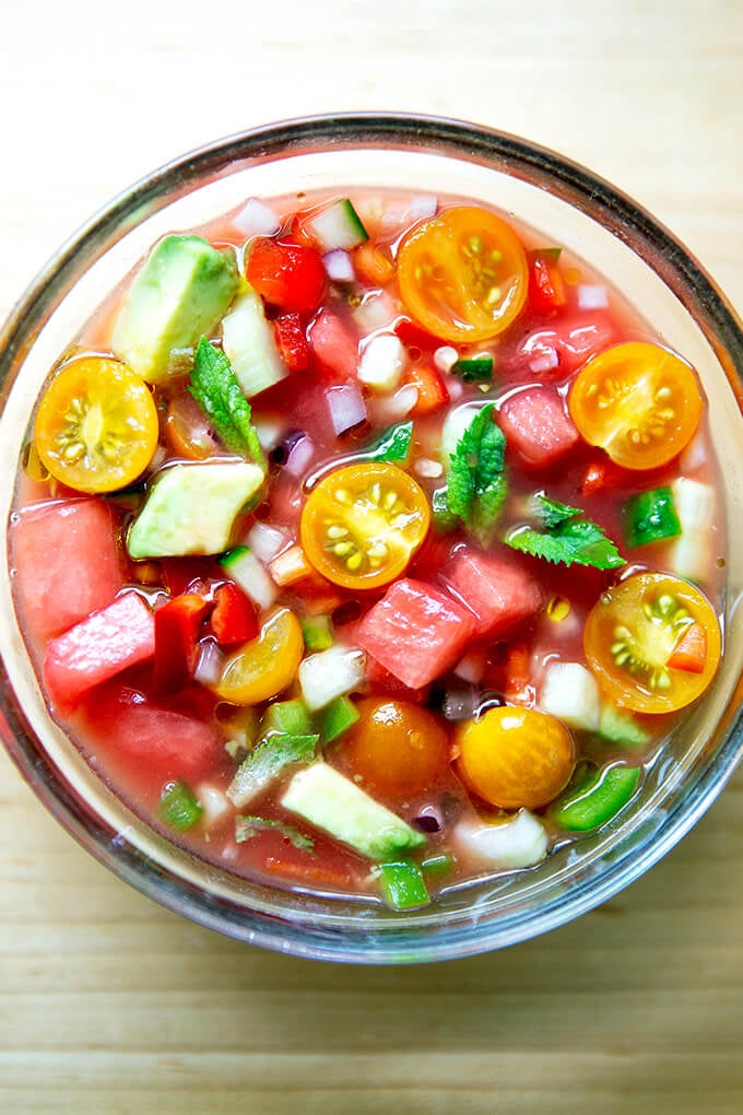 A glass bowl filled with watermelon gazpacho.