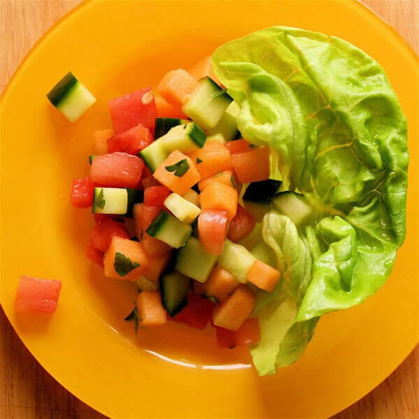 A plate of melon and cucumber salad.