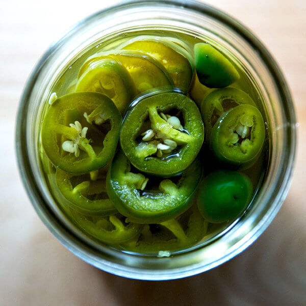 An overhead shot of a jar of pickled jalapeños.