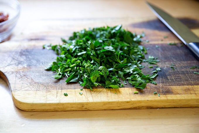 Chopped parsley on a board.