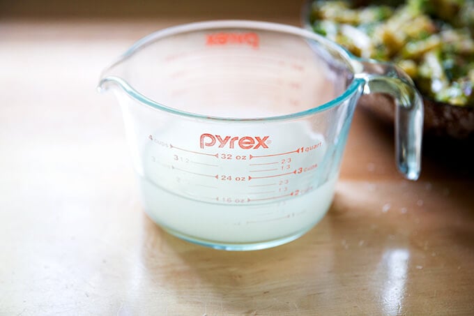 A Pyrex measure holding pasta cooking liquid.