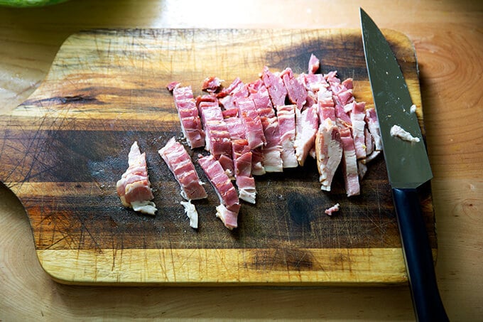 Bacon diced on a cutting board.