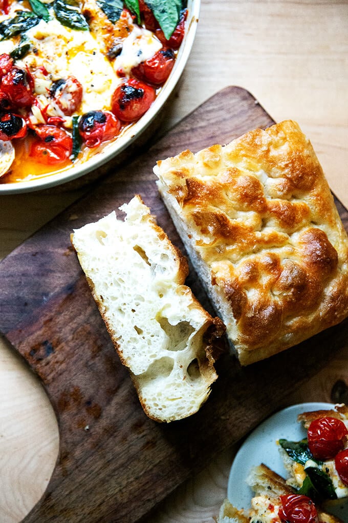 A slice of focaccia on a cutting board.