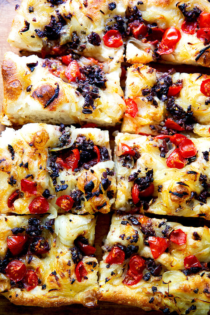 Cut pieces of pissaladière on a board.