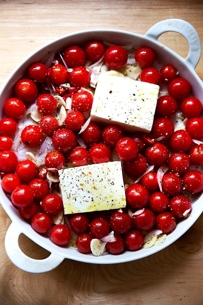 A baking dish with tomatoes and feta, ready for the oven.