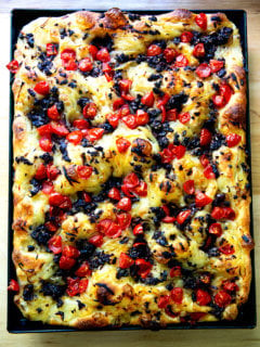 A large sheet pan holding just baked pissaladière.