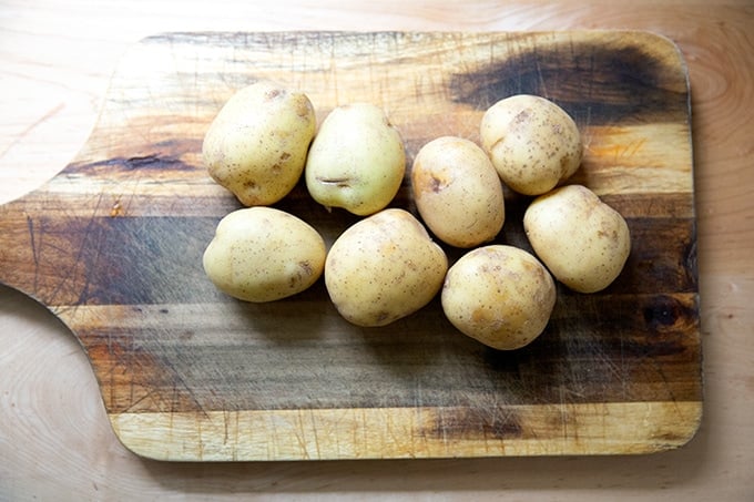 Yukon Gold potatoes on a cutting board.