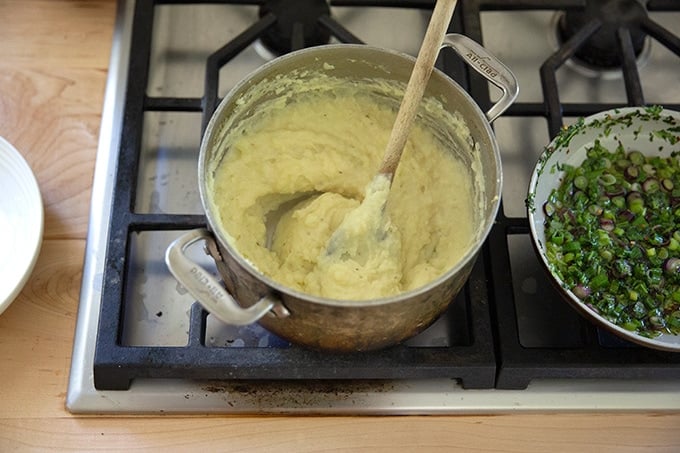 A pot of mashed potatoes on the stovetop.