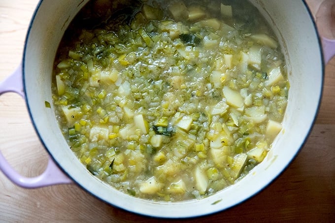 A large soup pot holding potato leek soup, ready to be puréed.