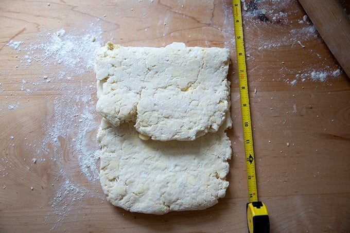 Folded biscuit dough on the counter top.