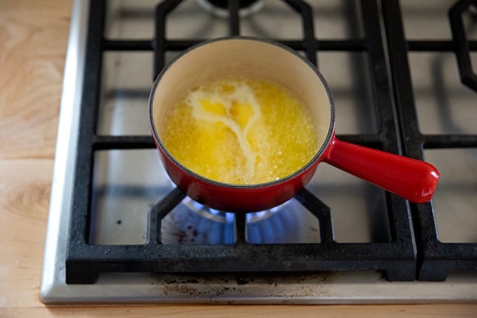 Butter melting in a sauce pan on the stovetop.