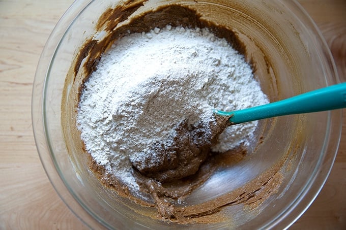 Dry ingredients added to wet ingredients for soft and chewy molasses cookies.