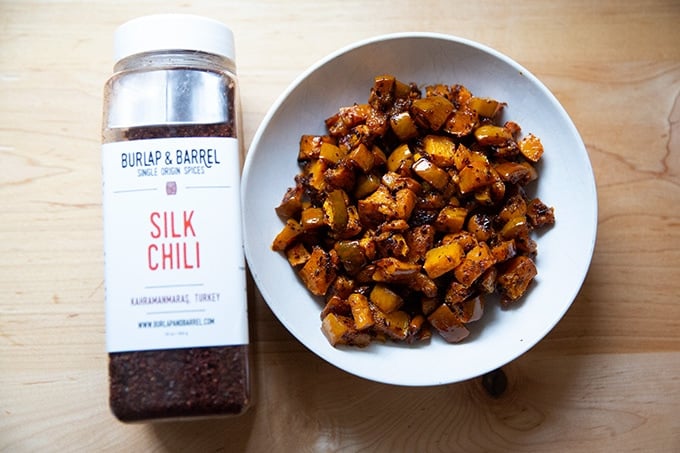 A bowl of roasted squash aside Burlap and Barrel silk chili