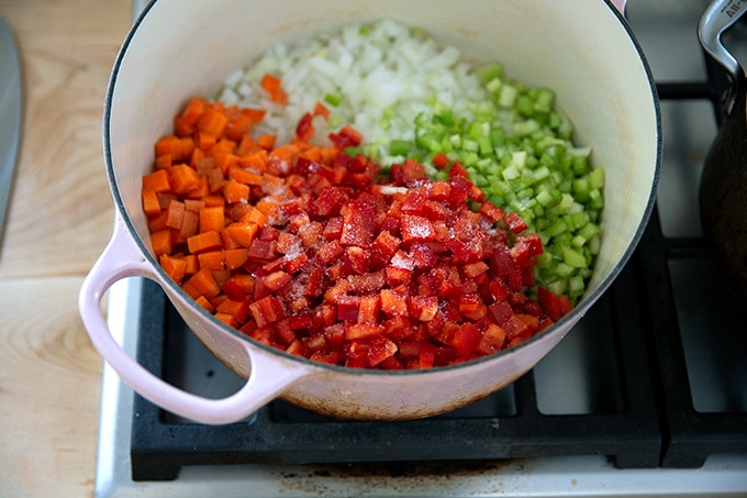 Vegetables added to the pot, seasoned with salt.