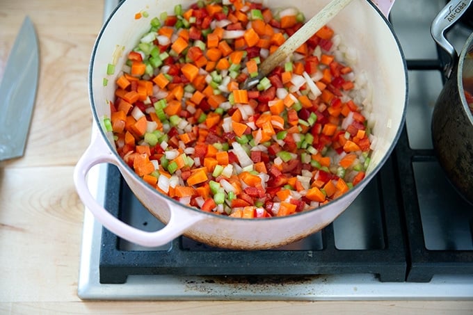 Vegetables sautéed in a large pot on the stovetop.