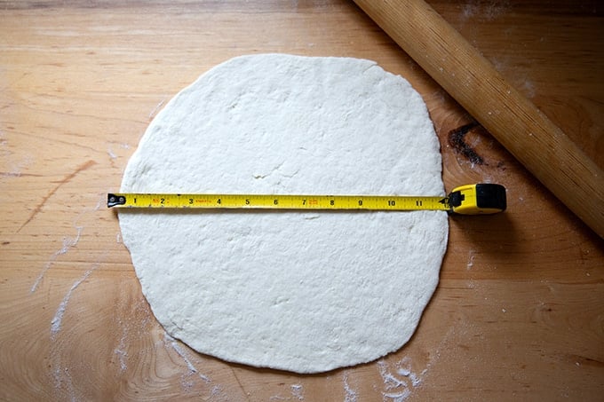 A gluten-free pizza dough round rolled out to 12 inches in diameter.