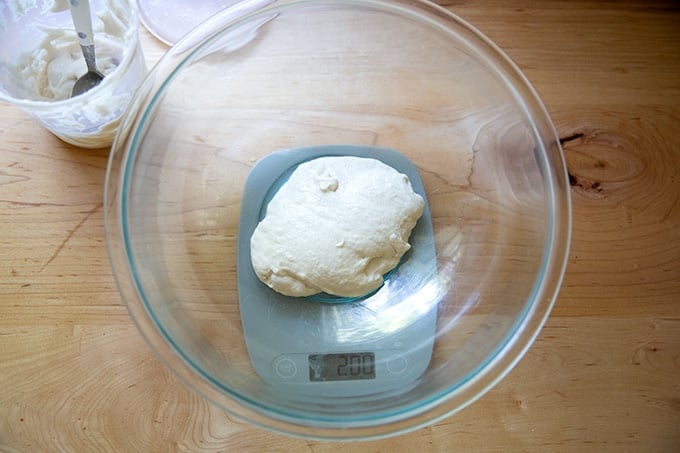 A bowl with 200 grams of sourdough starter in it.