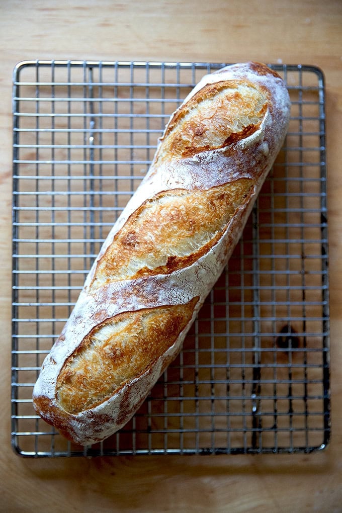 A baked baguette on a cooling rack.