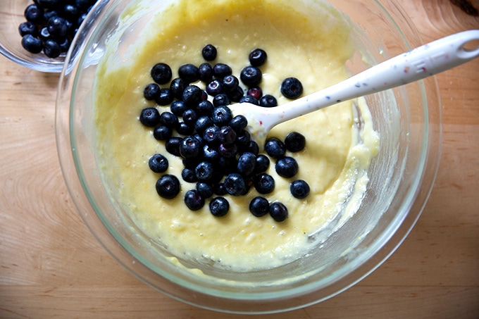 A bowl of partially mixed lemon-blueberry quick bread batter with the blueberries just added.