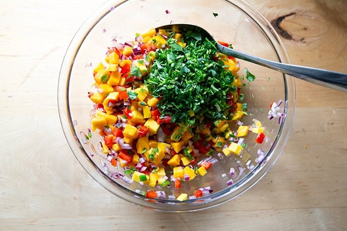 A large bowl of mango salsa in the works, cilantro just added. - 20