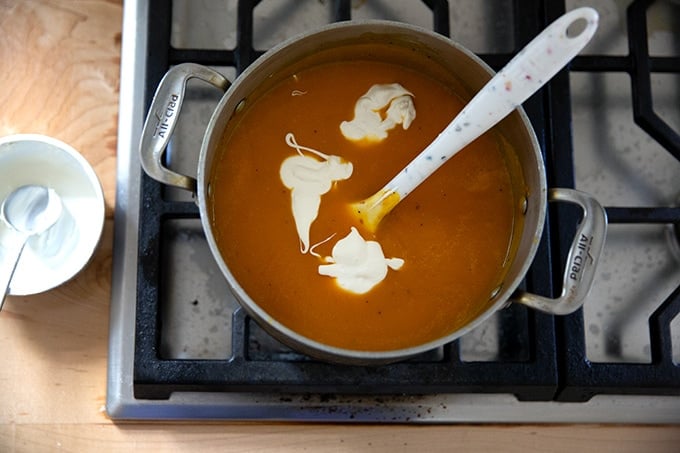 A pot of pureed roasted butternut squash soup plus 3 tablespoons of creme fraiche.