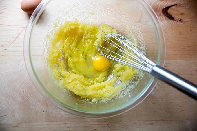 A bowl of partially mixed lemon-blueberry quick bread batter with the eggs just added.