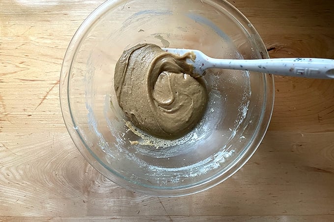 A bowl of cookie batter and a spatula.