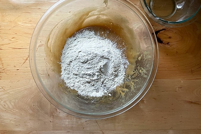 A bowl of white chocolate-madacamia nut cookie batter in the making.