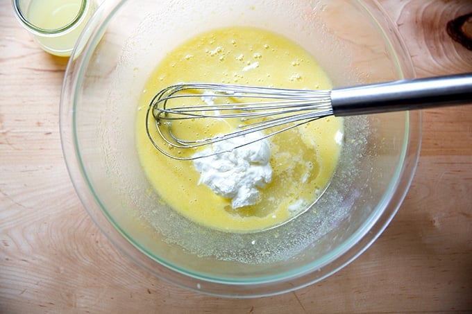 A bowl of partially mixed lemon-blueberry quick bread batter with the sour cream just added.