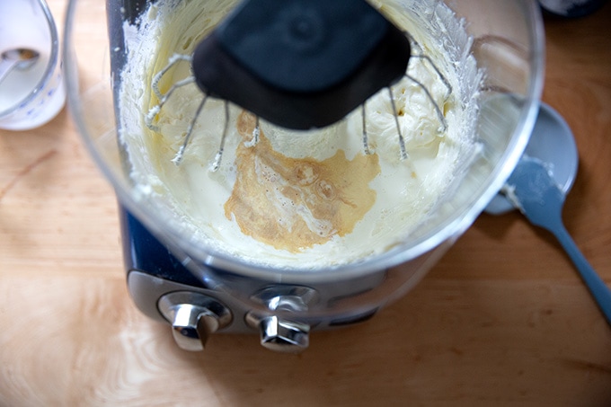 Adding the vanilla and heavy cream to the stand mixer.