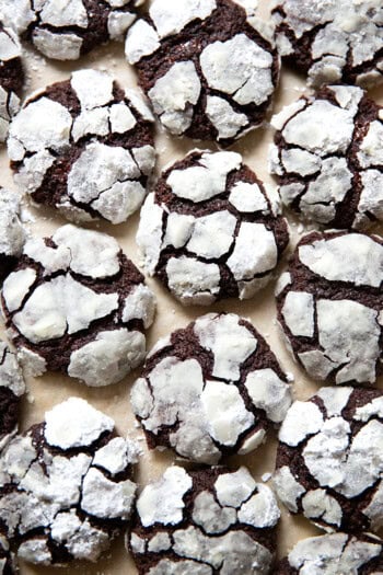 Just baked chocolate crinkle cookies on a sheet pan.