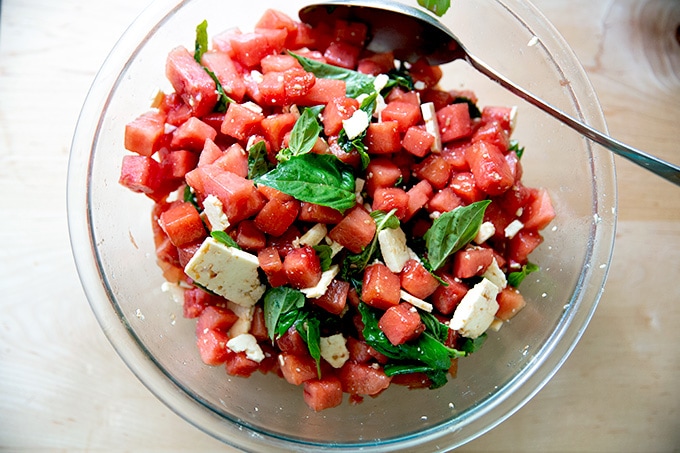 A tossed watermelon and feta salad in a large bowl.