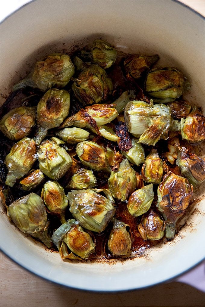 A large pot filled with just-cooked baby artichokes. - 9