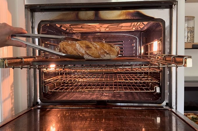 A baguette finished baking on a Baking Steel.