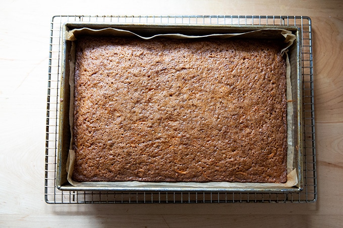 A just baked carrot cake on a cooling rack.