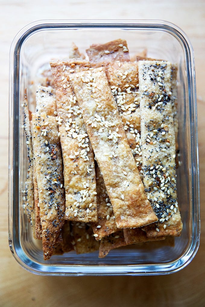 A container filled with homemade sourdough crackers.