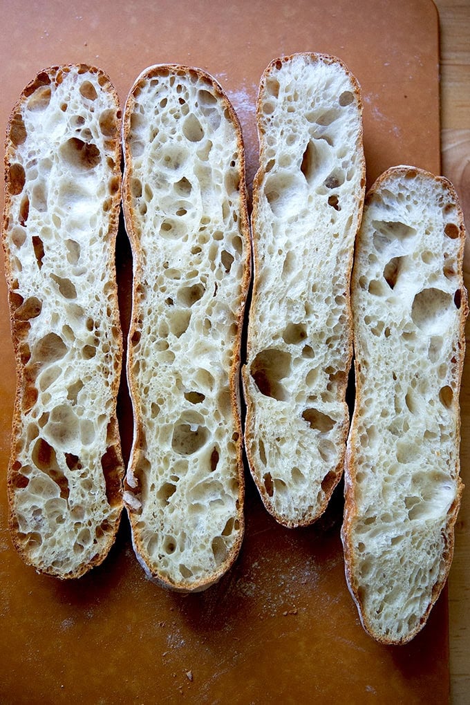 Two halved baguettes on a cooling rack.