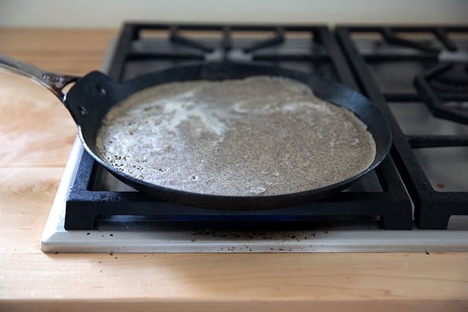 A nonstick skillet holding buckwheat crepe batter.