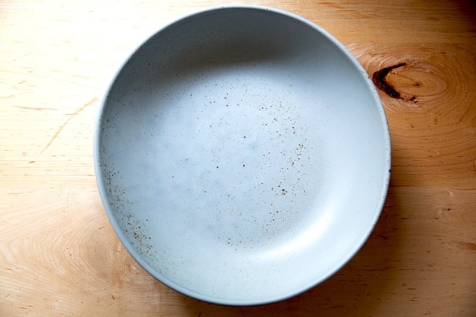 A blue fruit bowl on the countertop.